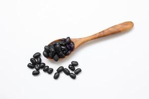 beans on a wooden spoon on a white background photo