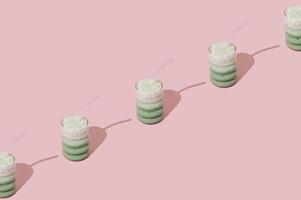 Creative summer pattern made of iced matcha latte on pastel pink background. Minimal healthy matcha latte concept. Trendy drink idea. Copy space. photo