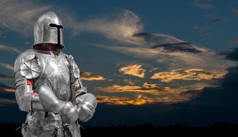 Knight in helmet and metal armor. 24-hour security. photo