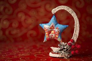 Christmas card. New Year decoration on a red background. Christmas tree toy. Rowan berries covered with snow photo