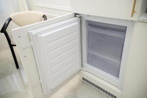 open refrigerator freezer door, empty and clean. Empty built-in refrigerator after cleaning. close-up of built-in appliances. High quality photo