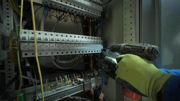 Electrician working on circuit breakers inside control panel video