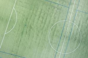 geometric patterns center of a turf soccer field, aerial drone view photo