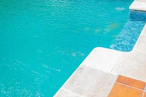 close up of clear blue pool water with bubbling effects and mosaic tiles photo