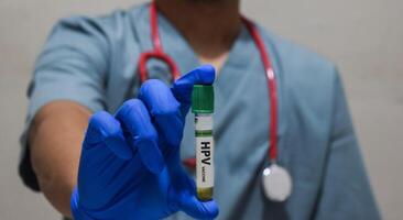 A doctor man holding a bottle with text HVP vaccine photo
