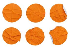Set collection of blank crumpled orange paper stickers in round shape isolated on white background photo