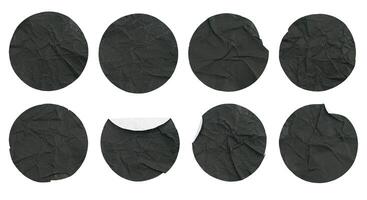 Set collection of blank crumpled black paper stickers in round shape isolated on white background photo