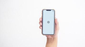 Yogyakarta, Indonesia, 2025 - Hand holdingHand holding smartphone that shows opening page of ChatGPT application, an artificial intelligence platform, on screen isolated on white background photo