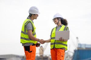Young Industrial Workers Shaking Hands at a Port, Port Engineers Discussing Logistics at a Shipping Yard, Team of Maritime Professionals Planning at a Harbor photo