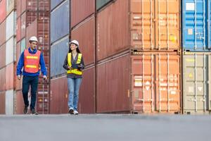 Logistics Team Inspecting Shipping Containers at Port, Industrial Workers Walking Through Cargo Terminal, Engineers at Container Yard photo
