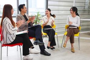 Asian Professionals Collaborating Meeting on Project, Business Team Discussion in Modern Office, Group of Colleagues Engaged in Brainstorming Session photo