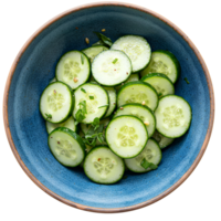 Sliced cucumbers in blue ceramic bowl top view flat lay . Cucumber salad with sesame seeds isolated. Refreshing sliced summer cucumber salad top view png