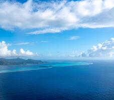 An Aerial view of Tahaa island, French Polynesia, with turquoise lagoon and reef photo