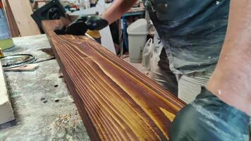 Paint is Applied to Wood Planks in the Carpentry Shop video