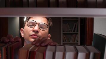 A man in glasses peeking out from behind a book shelf video