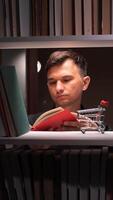 Man reading book in front of shelves with shopping cart video