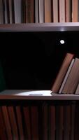 A book shelf with a flashlight on it video