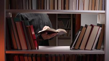 A man reading a book in a library video