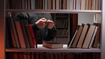 A person holding a book and a cross video