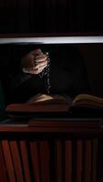 A person is sitting in a chair with a book in front of them video