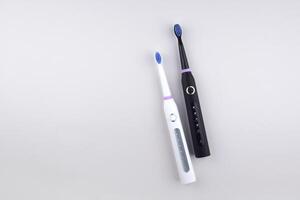 Two Modern electric ultrasonic toothbrushes with rechargeable battery. photo