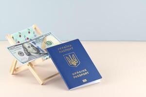 The Ukraine passport and chaise lounge with dollars. photo