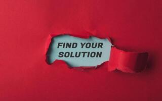 Torn red paper with words Find your solution symbolizing challenge and determination photo
