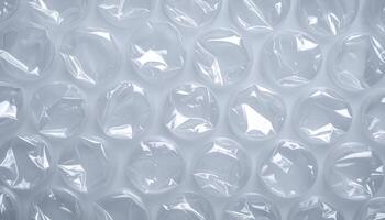 top view of transparent plastic bubble wrap texture with circular air pockets in soft lighting for packaging background photo
