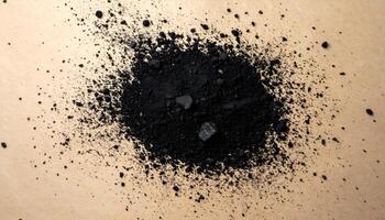 charcoal dust scattered on brown paper texture, top view of natural black powder with rough fragments for artistic, cosmetic or organic design concepts photo