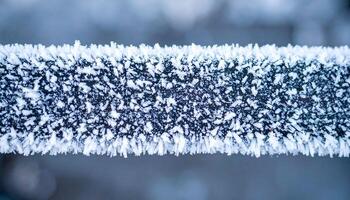 macro close-up of frost crystals on metal railing in winter, showing icy texture and sharp frozen patterns in cold weather conditions photo
