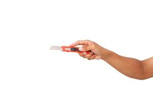 Hand holding a box cutter, isolated on white, displaying tool use and dexterity photo