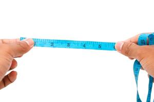 Hands holding a blue measuring tape, demonstrating precision measurement in garment creation photo