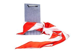 Blue Shopping Bag Adorned with a Vibrant Red and White Scarf photo