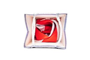 Overhead view of a gift bag filled with a red and white patterned fabric photo