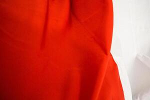 Vivid contrast of red and white fabric creating an abstract and dynamic visual texture photo