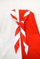 Red and white scarf draped over a white and red background showcases a vibrant contrasting design suitable for various creative projects photo