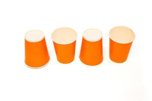 Row of Vibrant Orange Paper Cups Isolated on a Clean White Background Offering Versatile Visuals photo