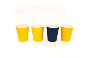 Four colorful paper cups arranged on a clean white background in a horizontal view photo