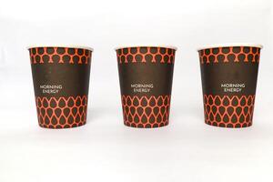 Three paper cups with a 'Morning Energy' print on a white background suggesting refreshment photo