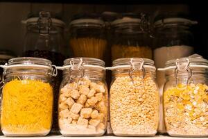 banner stand in a row of glass jars on a shelf with bulk products, the concept of organizing a kitchen space photo