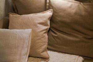 pillows of different sizes made of natural cotton close-up, neutral color photo