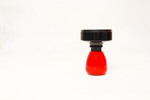 Close-up shot of a modern stamp with a red handle isolated on white background, studio setting, suitable for office supplies promotion photo