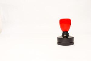 Close-up shot of a black and red rubber stamp on a white background, ideal for corporate or business use photo