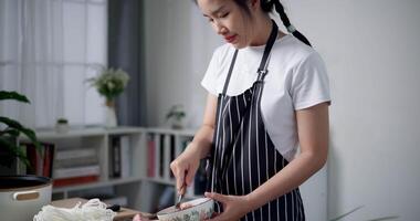 Handheld high angle view shot, Woman is mixing minced pork with various seasonings in a bowl. video