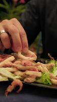 Man Using Hands To Eat Fried Squid Rings During Dinner video