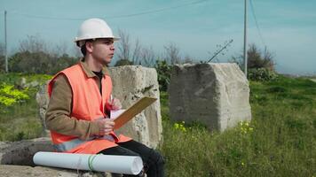 Architect In The Nature Sitting While Taking Notes About The Project video
