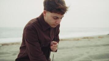 Man Crying While Praying On The Shore During Winter video