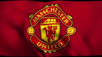 Manchester United C.F. flag waving in slow motion against blue sky, editorial animation, looping seamlessly, close up video