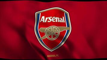 Arsenal F.C. flag waving in slow motion against blue sky, editorial animation, looping seamlessly, close up video