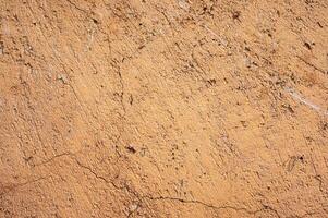 Earthen wall texture of clay house structure. These walls are constructed by ramming a mixture of aggregates, including gravel, sand, silt and a small amount of clay. photo